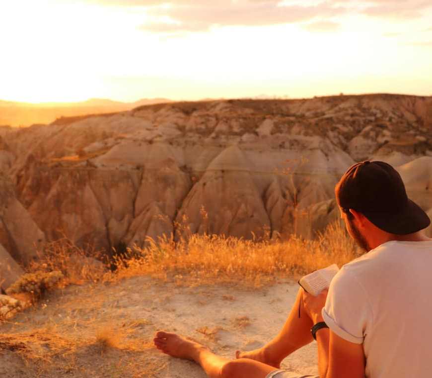 Eme The Globetrotter writing in Cappadocia at sunset